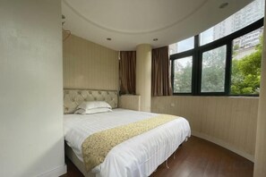 A bedroom with a large bed, a curved ceiling, and a window with a view of greenery. - Lanshan Hostel (Shanghai)