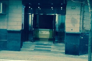 A building entrance with a metal gate and steps leading up to it. - Lanshan Hostel (Shanghai)