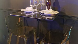 A dining table set with wine glasses and plates, two chairs, a decorative butterfly, and three wall-mounted mirrors. - Love room - La Villa 1900 - L'Instant X - Chic cocoon for a night for two (Chérancé)