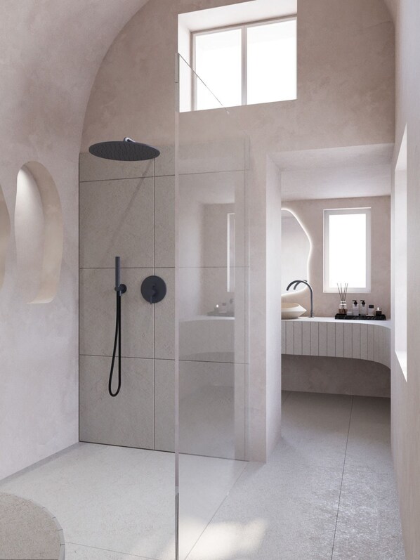 A modern bathroom with a glass-enclosed shower, a vanity with a sink, and a window providing natural light.