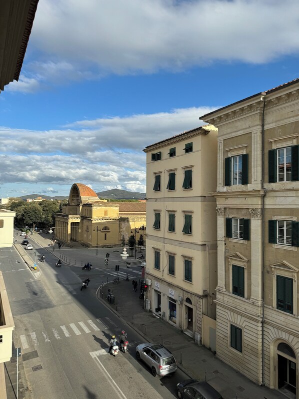 A street view with buildings, a fountain, and a clear sky.