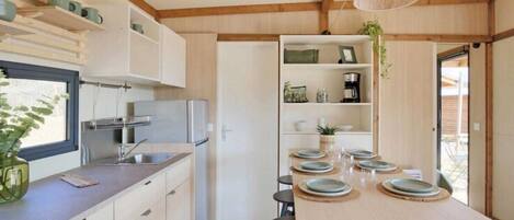 Fridge, microwave, stovetop, dining tables