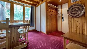 A wooden interior with a dining table and chairs, a red carpeted floor, and a wooden ceiling. - 200m from resort center, view forest, terrace, balcony, fireplace or stove, tv, 42m², La Plagne (La Plagne)