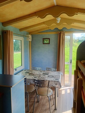 Enjoy meals in this room's dining area, which seats four, with a view of the surrounding landscape.