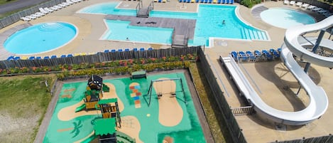 Alberca al aire libre, sombrillas en la alberca y camastros