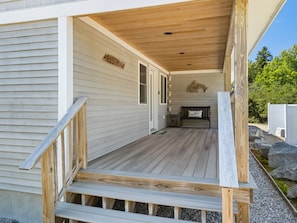 A wooden deck with a bench and a sign that reads 'EASTWIND.' - Ocean Breeze East Wind – Modern 2BR/2BA home by Cr (Owls Head)