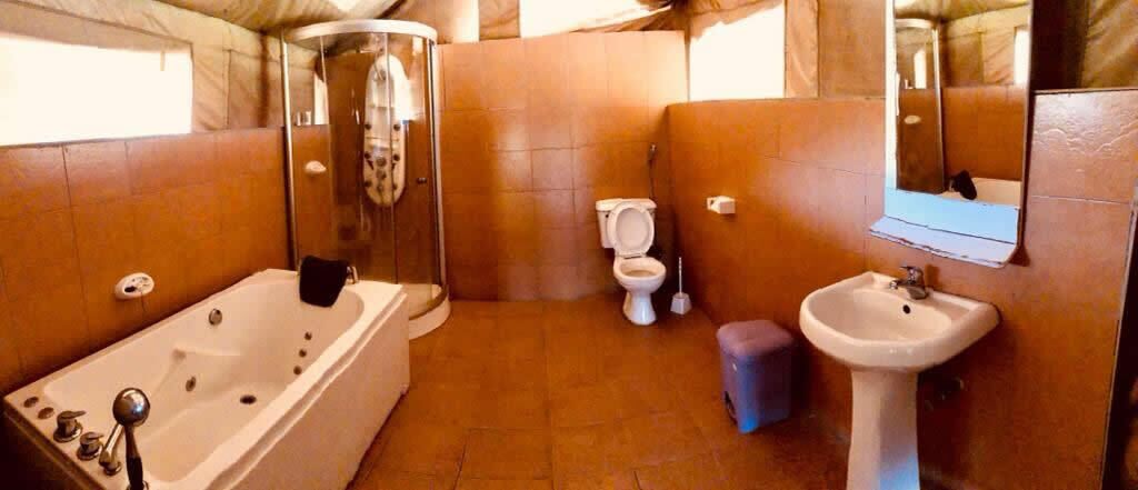A bathroom with a bathtub, toilet, and sink.