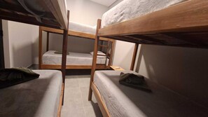 A bunk bed room with wooden frames and grey bedding. - JD Hotel cravinhos (Cravinhos)