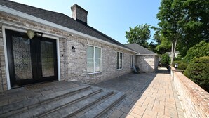 A stone house with a brick exterior, a front door, and a small porch area. - Hershey Ranch Retreat: Spacious, luxurious, fun w/ fire pit, arcade, game room. (Hershey)