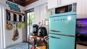 A compact kitchen with a teal Galanz refrigerator, a coffee maker, and a microwave. - The Sunburst Oasis  (Palm Harbor)