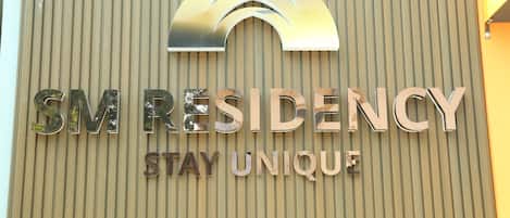 A sign for SM Residency with the tagline "Stay Unique".