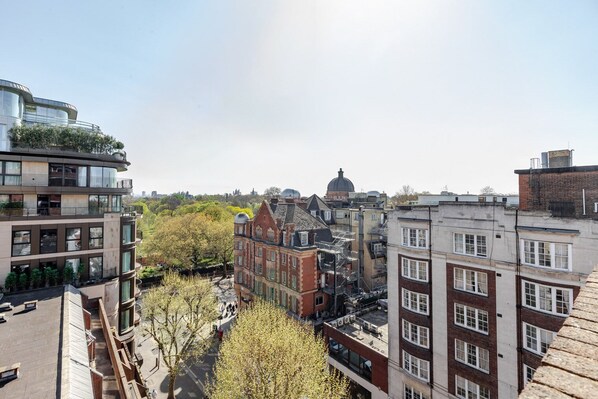 A multi-story building with a modern glass facade, adjacent to traditional brick buildings.