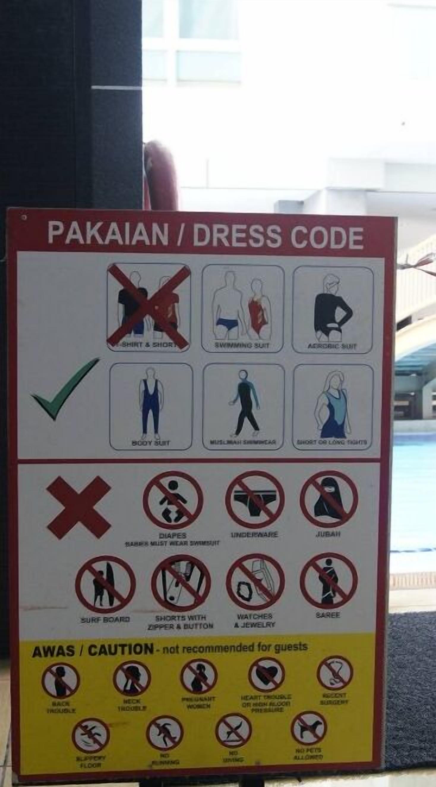 A sign detailing a dress code for a Pakaian, including acceptable and unacceptable attire.