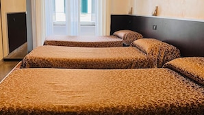 A hotel room with two beds, a TV, and a window with curtains. - FUNNY HOLIDAY ROME (Rome)