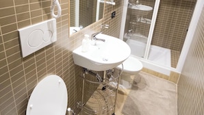 A modern bathroom with a toilet, sink, and shower. - FUNNY HOLIDAY ROME (Rome)