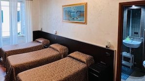 A hotel room with two beds, a painting on the wall, a bathroom with a sink, and a view of the outside. - FUNNY HOLIDAY ROME (Rome)