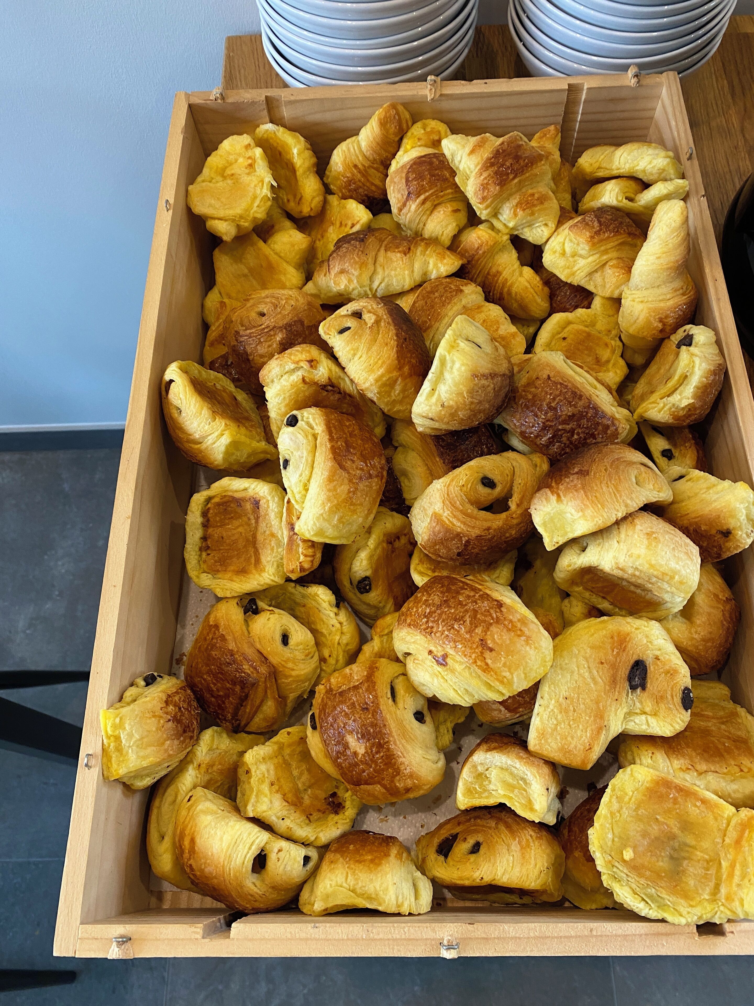 A wooden box filled with assorted pastries.