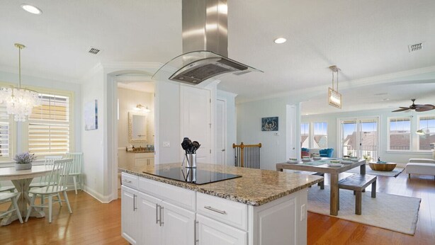 A spacious kitchen with white cabinetry, a granite countertop, and a stainless steel range hood. - Villa Vilano |Summer by the beach! (St. Augustine Vilano Beach)