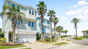 A beachfront property with multiple-story houses, palm trees, and a clear sky. - Villa Vilano |Summer by the beach! (St. Augustine Vilano Beach)