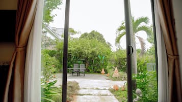 Deluxe Triple Room, Garden View | In-room safe, desk, laptop workspace, blackout drapes