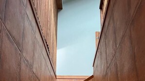 A staircase with a modern design, made of brown tiles, leading upwards. - Beachfront Four bedroom Apartment (Sveti Stefan)
