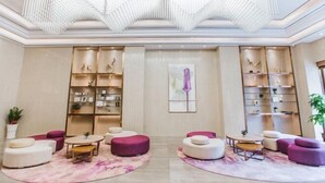 A modern lobby with a chandelier, seating areas, and bookshelves. - Lavande Hotel(Dongguan Dongcheng Metro Station Wanda Plaza) (Dongguan)