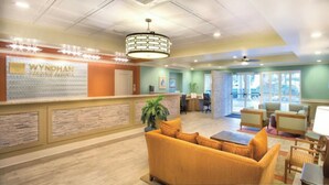 A reception area with a reception desk, seating area, and a large window providing natural light.