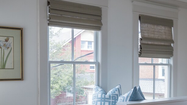 A corner seating area with a table and chair, large windows with blinds, and a framed picture on the wall. - Charming Downtown 2 BR Apartment Steps from Downtown Mall (Charlottesville)