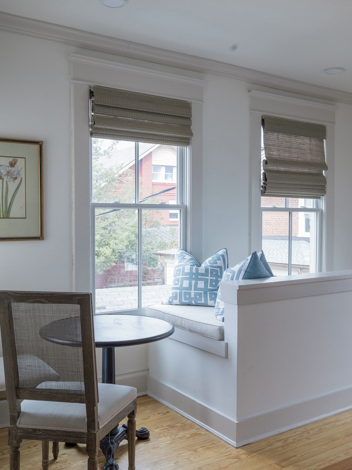 A room with a window seat, a dining table, and a chair.