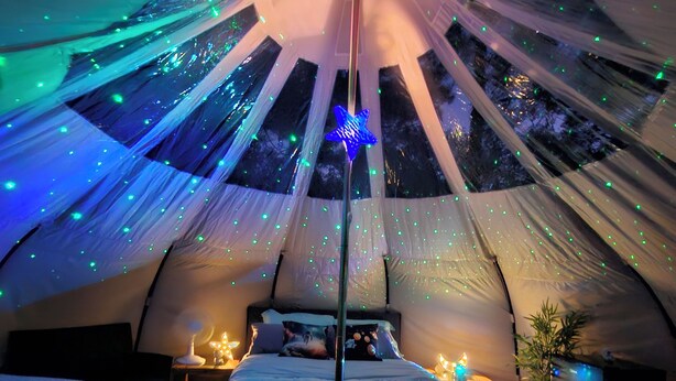 A tented accommodation with a bed, bedside lamps, and a star decoration. - Milky Way with AC and WiFi, glamping near Houston (Cleveland)