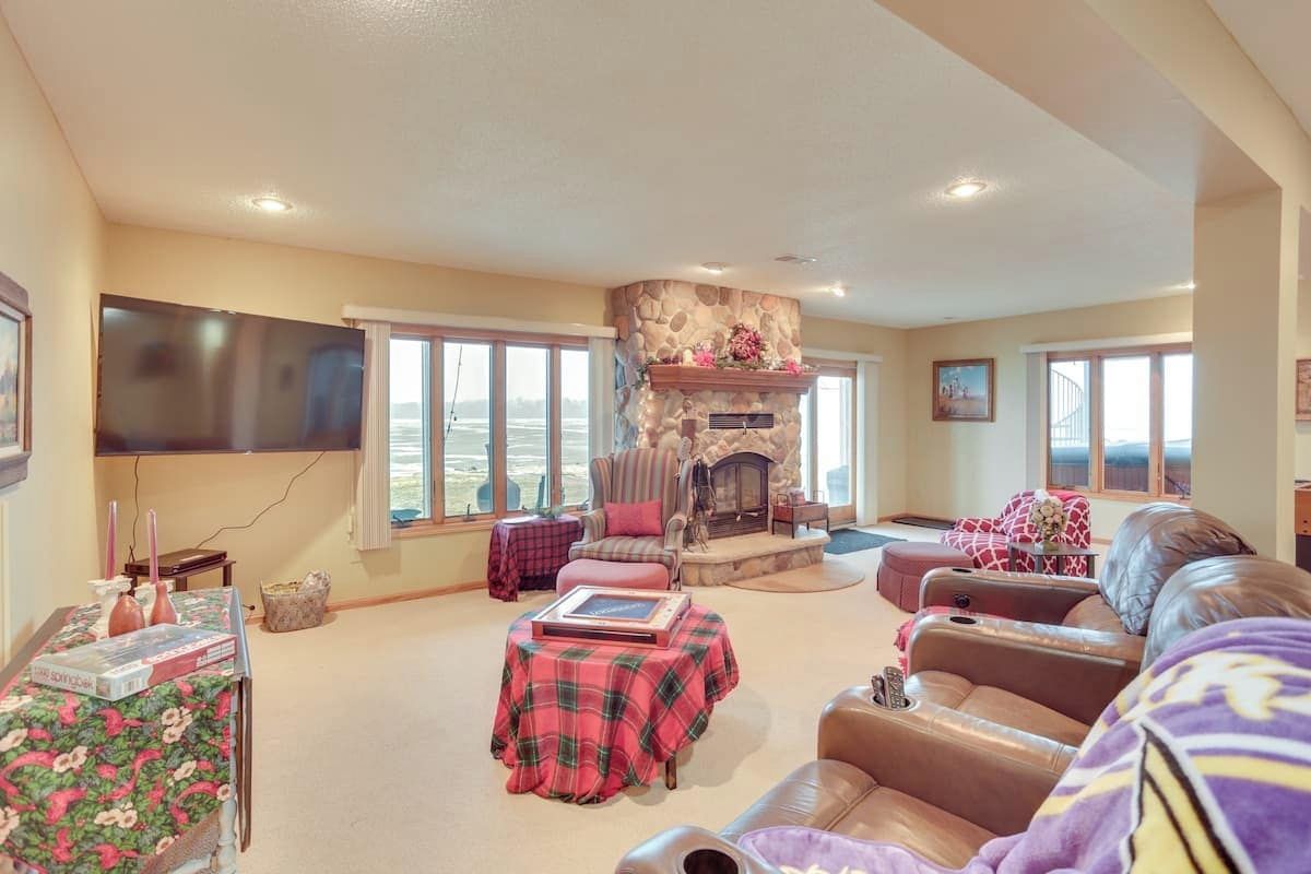 A living room with a fireplace, a television, and a sofa.