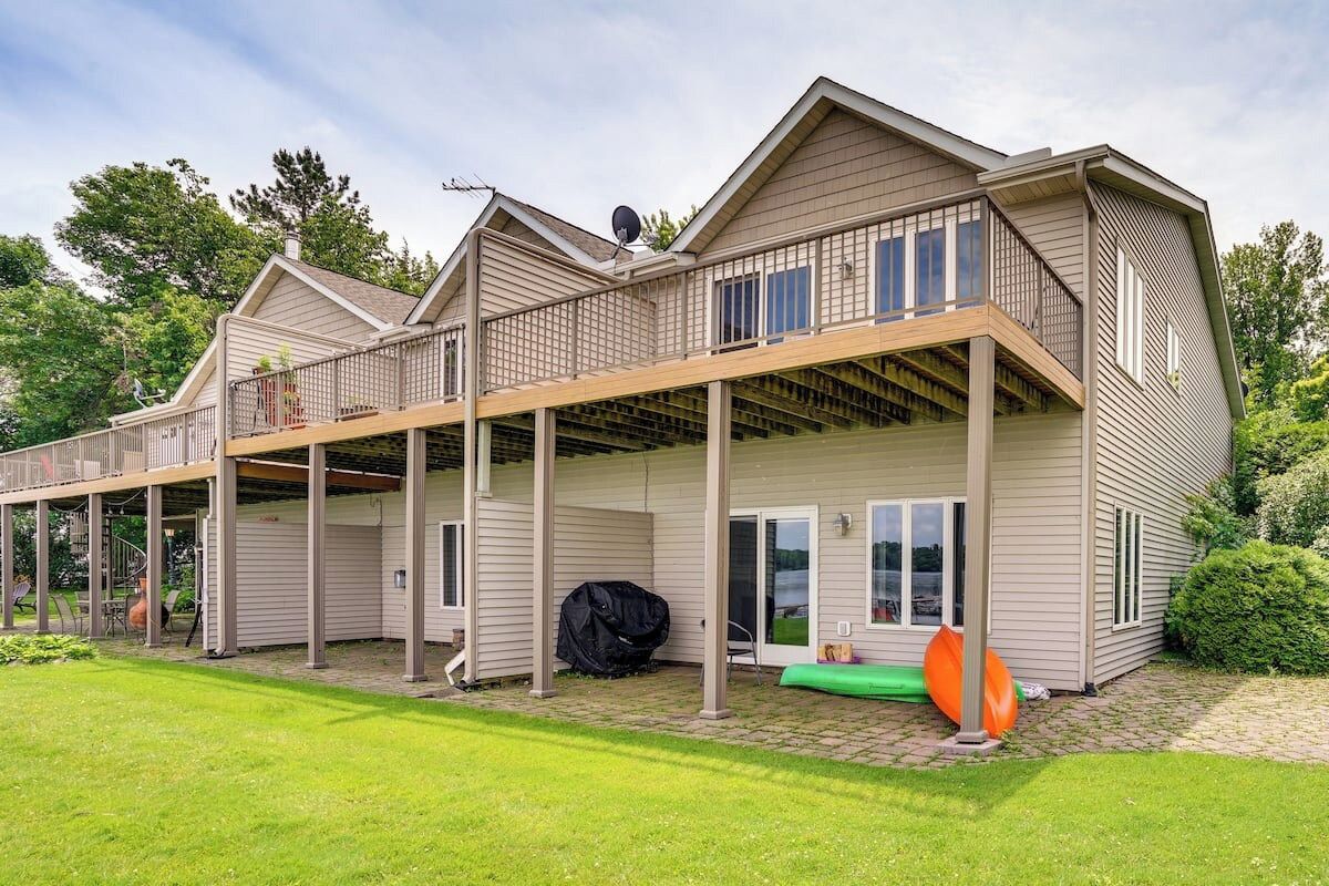 A two-story house with a covered patio and a garage.