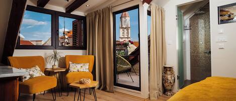 Deluxe Room, Balcony, City View | Living area | 48-inch Smart TV with digital channels