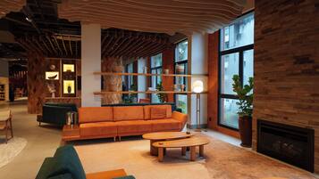 A modern interior with a sofa, coffee table, and a fireplace.