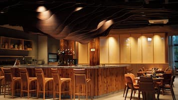 A bar area with wooden chairs and a bar counter.