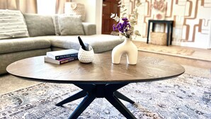 A round wooden coffee table with a white vase and a book titled "Why We Sleep" by Matthew Walker. - Parkside 4-bedroom house with complete fenced in yard in tranquil Santa Rosa. (Santa Rosa)