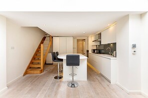 Enjoy meals in the spacious kitchen and dining area, featuring a central island and modern appliances.