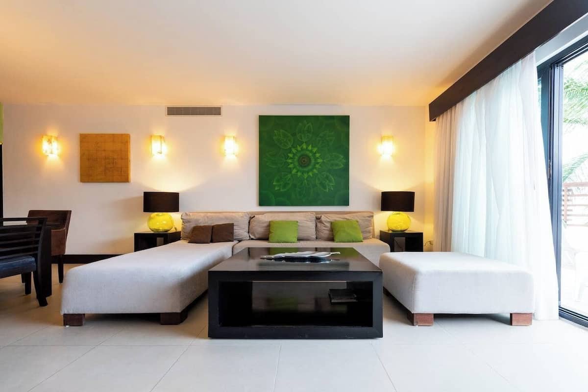A modern living room with a sofa set, a coffee table, and two side tables with lamps.