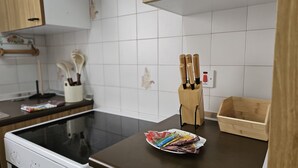 A kitchen with a stove, a knife block, and a tray of snacks. - 74 LCA - Stay Sea Gate Apartment (Larnaca)