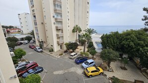 A high-rise residential building with a parking lot, a pool, and a view of the sea. - 74 LCA - Stay Sea Gate Apartment (Larnaca)
