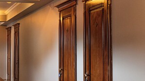 A hallway with wooden doors and a staircase. - RITSA HOTEL (Batumi)
