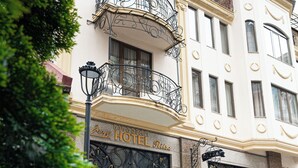 A hotel with ornate iron balconies, large double doors, and a classic architectural style. - RITSA HOTEL (Batumi)