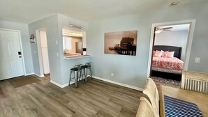 A compact apartment with a kitchenette, a dining area, and a bedroom. - The Lighthouse - Steps from Beach (Fort Myers Beach)
