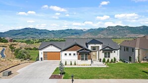 A modern two-story house with a garage, a front yard, and a driveway. - Mountains and Horses and Deer, Oh My! (Heber City)