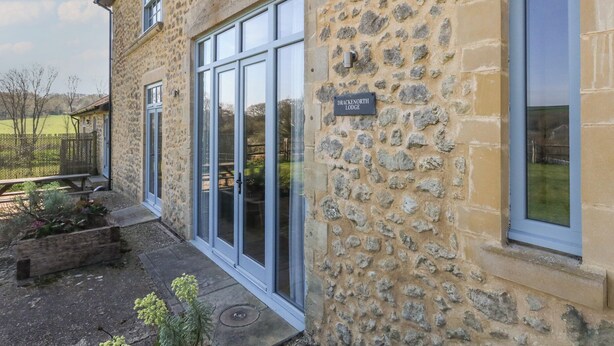 A stone building with a sign reading "Dracken North Lodge." - Stapleford Farm (Beaminster)