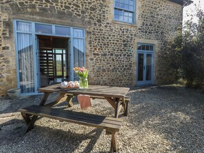 A stone building with a wooden table and benches in front. - Stapleford Farm (Beaminster)