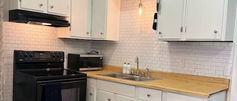 Fridge, microwave, stovetop, coffee/tea maker