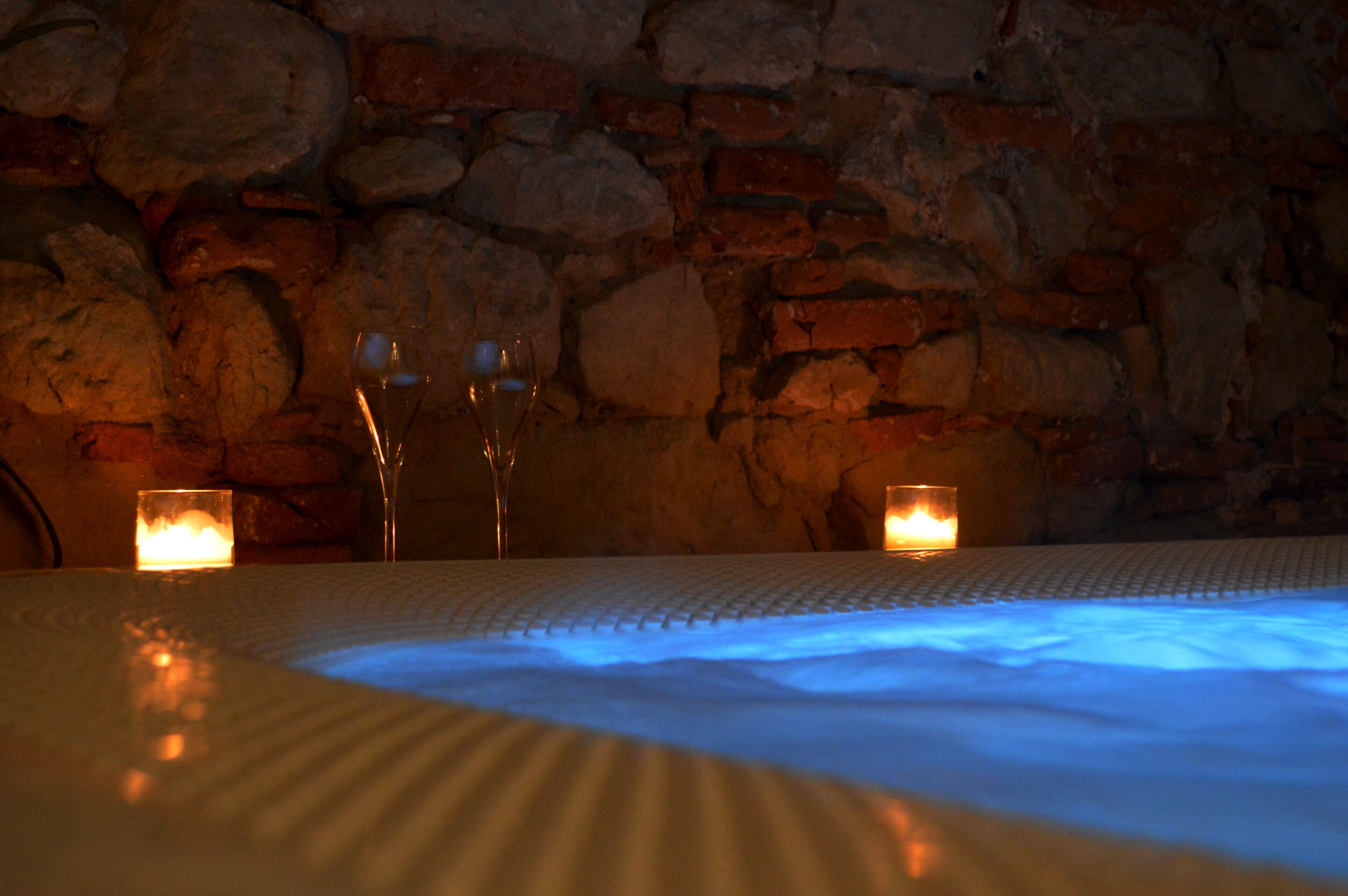 A stone wall with candles and a heated floor.