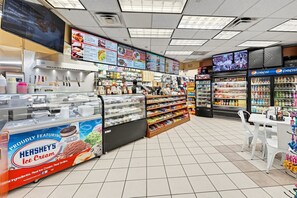 A food court with a variety of food options, including a display of Hershey's ice cream. - Luxury 1BR Royale Suite Near Disney (Kissimmee)
