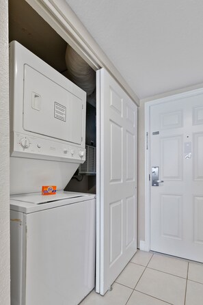 A laundry room with a washer, dryer, and a door to a closet. - Spacious 2BR Villa Near Disney (Kissimmee)
